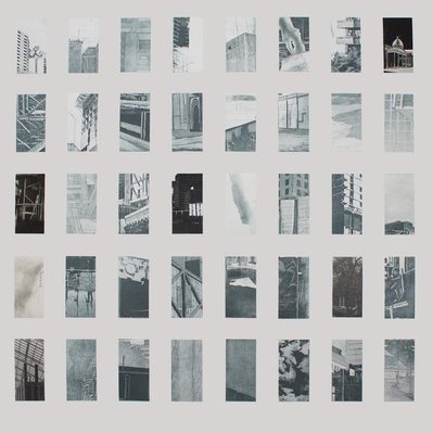 A grid of small glimpses of architectural details like windows, streetlights, concrete surfaces, and doorways, printed in silvery-blue and arranged on a white sheet of paper.
