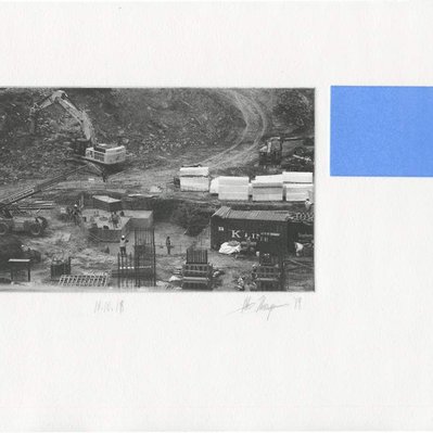 A photographic print showing several piles of materials, and concrete pillars. There is a blue rectangle to the right of the image.