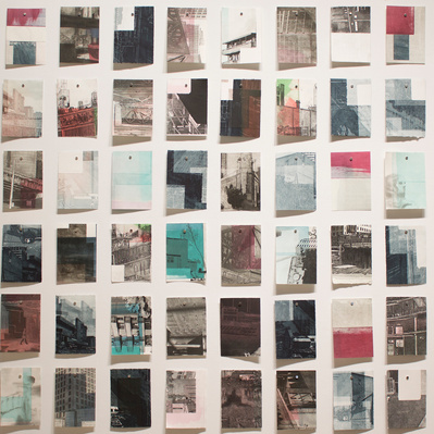 A large grid of colourful prints of architectural details pinned to a white wall.