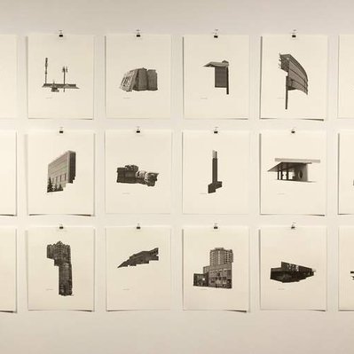 30 photographic prints of architectural details, centred on blank sheets of paper, in three rows of ten.