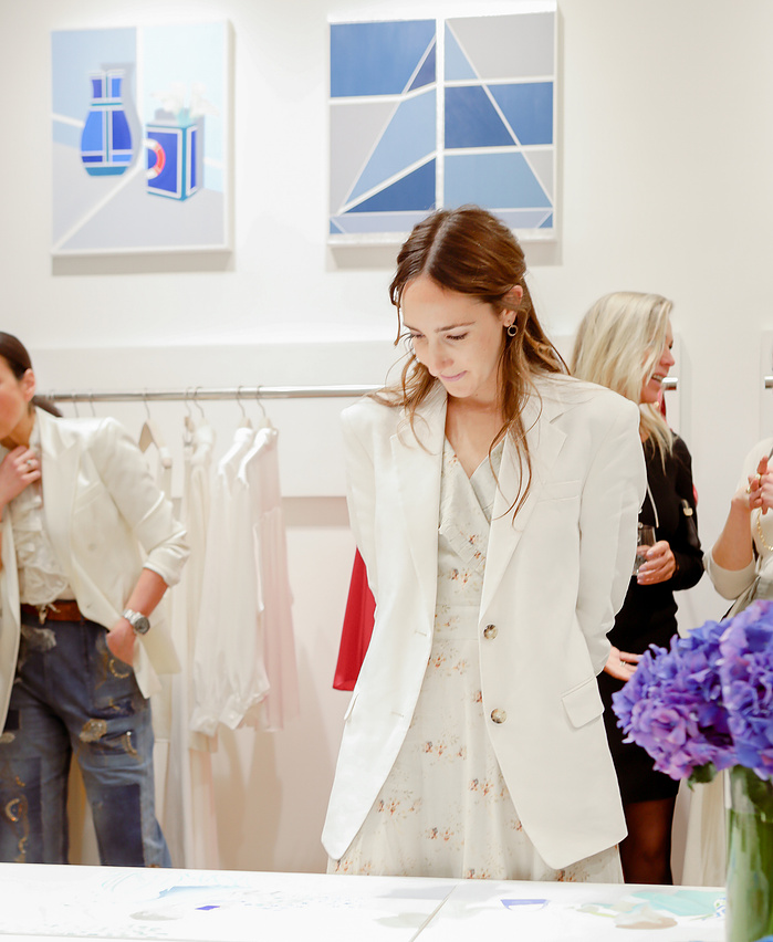 Carolyn Floersheimer admiring a diptych painting at the spring show