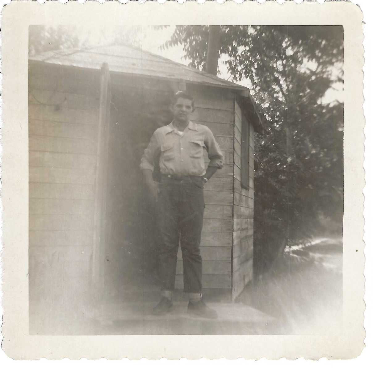 My Grandpa, Gene Swabby, standing on the front step of the shack that he lived in during his time in Washington state as an apple picker. 