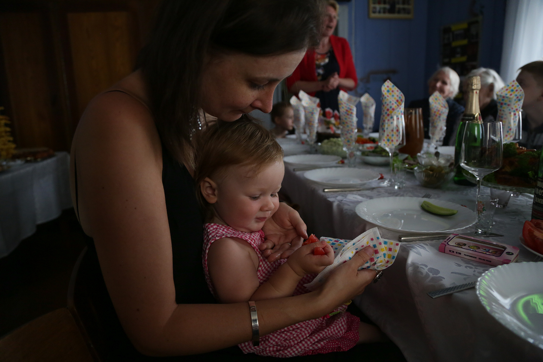 Rasa Mortuze feeds her daughter at a family gathering to celebrate her mother-in-law's 60 birthday in Marijampole, Lithuania on June 29, 2019.