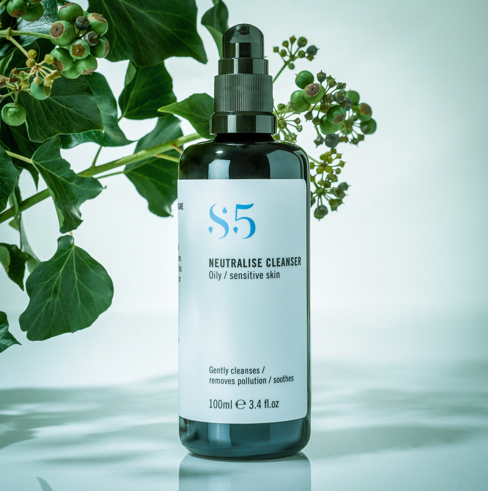Studio Product Photography set up of bottle of natural skincare beauty serum with plant in background