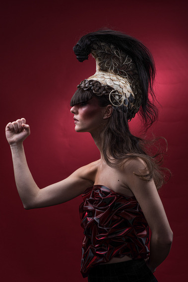 Artistic representation of a Spartan-inspired fashion look with sculptural hair in a stylish photo studio