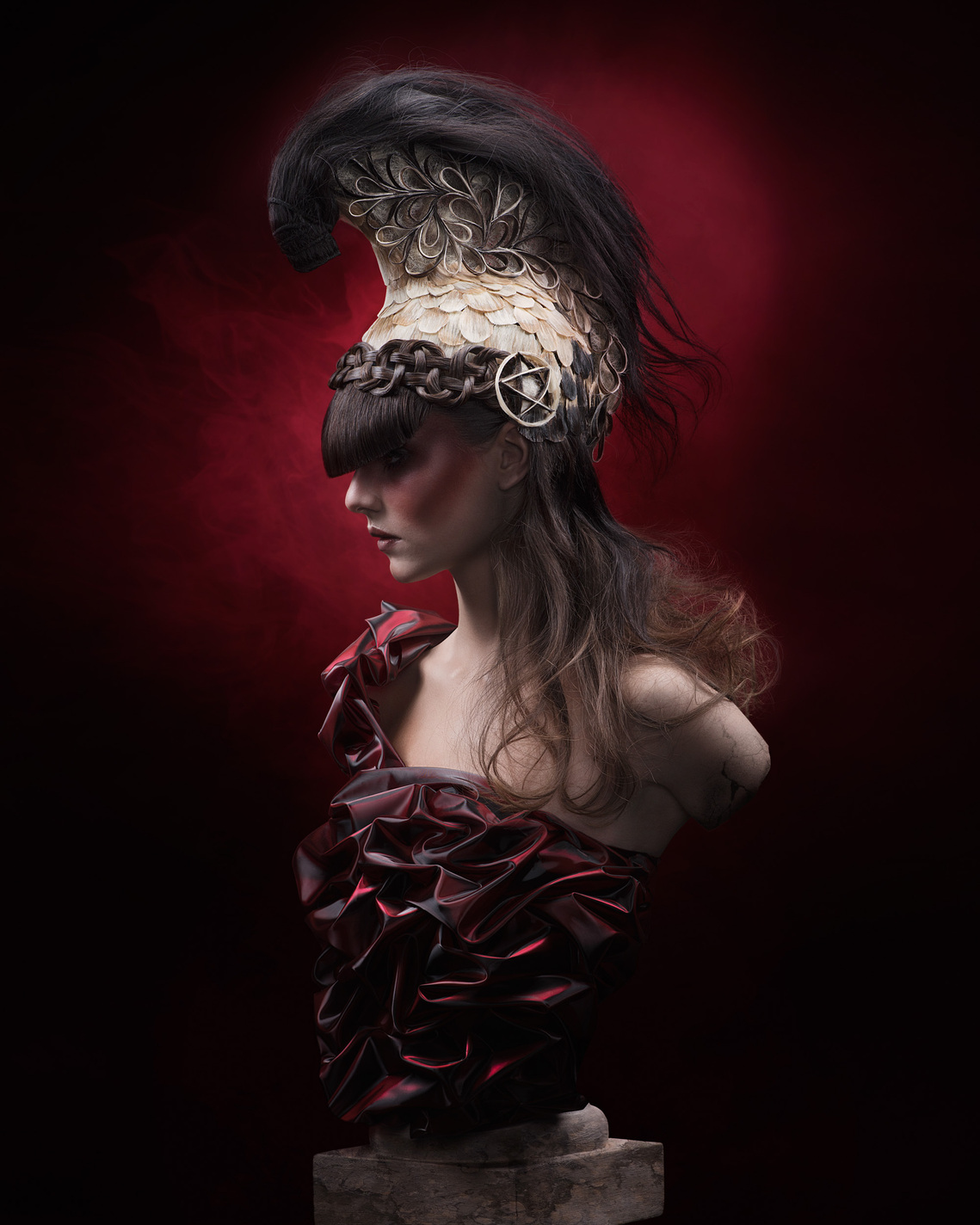 Striking portrait of a model with bold, artistic hair and a Spartan warrior-inspired outfit.