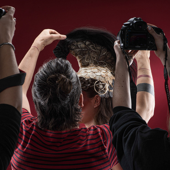 Artistic photo of a model styled as a Spartan warrior with sculptural hair in a Montreal fashion studio