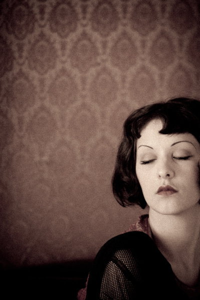 Vintage looking  young caucasian woman with bob & eyes closed and pouted lips