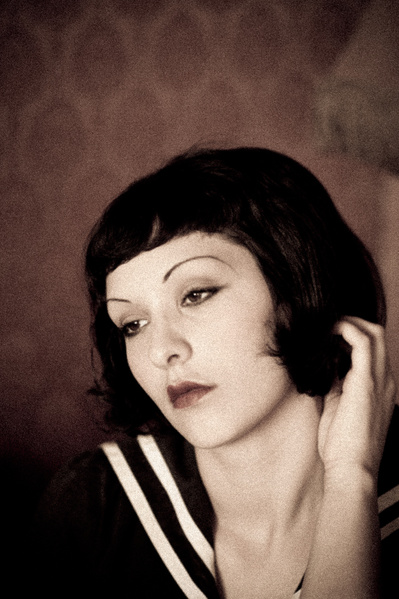 Vintage looking  young caucasian woman with pensive gaze