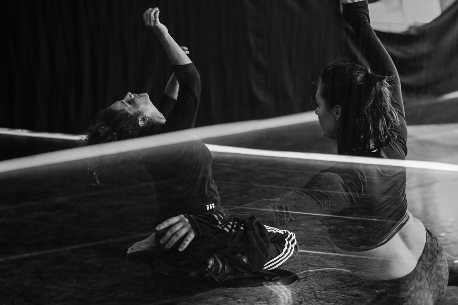 Double exposure of dancers in motion  during a routine in a dance studio