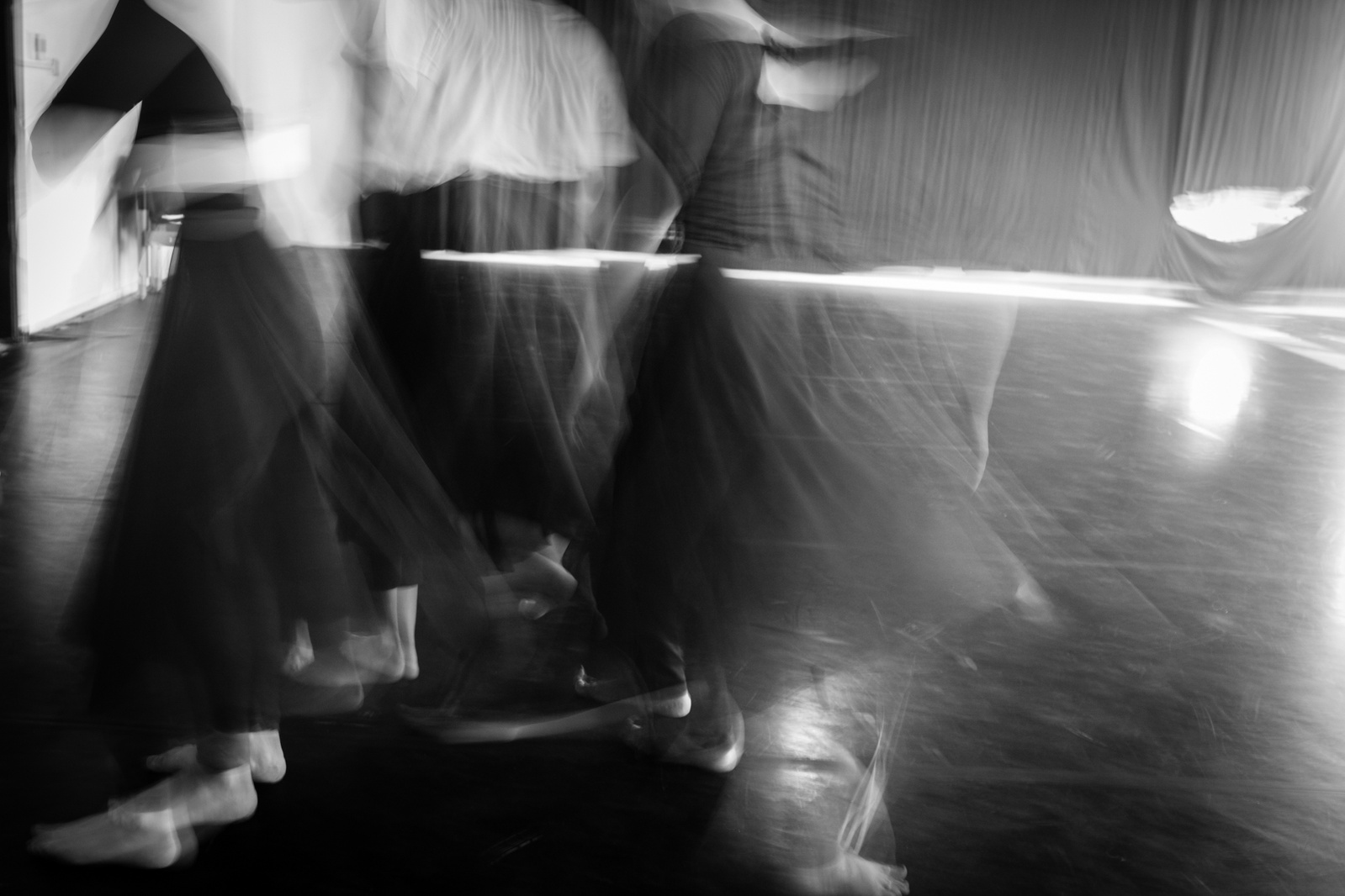 Long exposure of dancers in motion in a dance studio