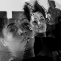 Double exposure close up of a dancer in motion with waving hair in front of her face
