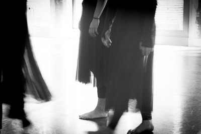 Detail of dancer's skirts moving in soft light in a dance studio