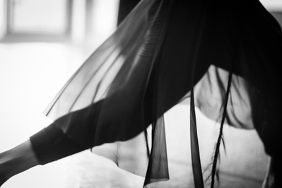 Detail of dancer's sheer skirt while dancing in motion in a dance studio
