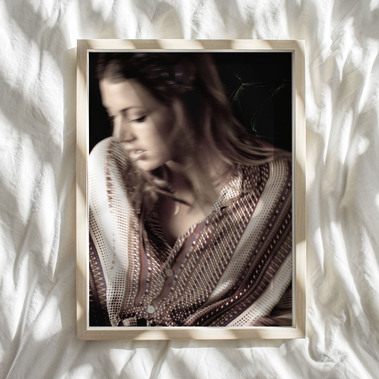 Framed portrait image of woman against a light-and-shadow background