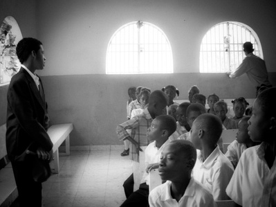 Haitian children attending a dimly lit church