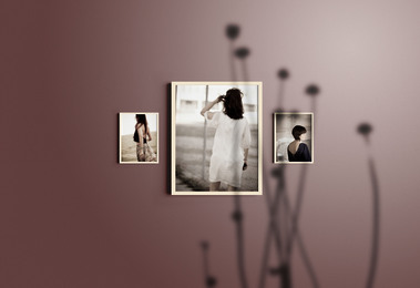 3 framed images on purple wall