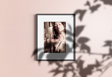 Framed image of woman against purple wall