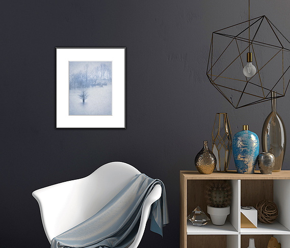 A dark wall works so well with a minimalist picture. And monotones stand out against black. Weave in a touch of the blue with a throw and a small vase.
