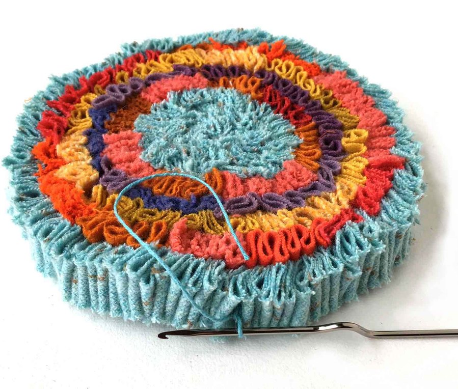 This is the beginner Hot Mat free pattern, or the center of a shirret rug, from the Easy three-minute crochet and shirret online videos, luxury from fabric scraps.