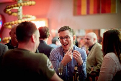 Best corporate kick-off and award ceremony event photographer Josh Caius. This photo was taken at Ham Yard Hotel in London. This is a candid image of people enjoying the after-party.
