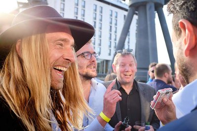 Corporate fun day photography at Sunborn Yacht Hotel by Josh Caius, with magician Magic Mike for a finance firm in London.