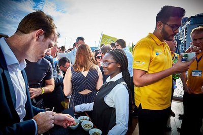 Party event photographer Josh Caius for Sunborn London Yacht Hotel corporate event, which is next door to ExCel Centre London. Candid photo of people eating finger food during a corporate party on the yacht.