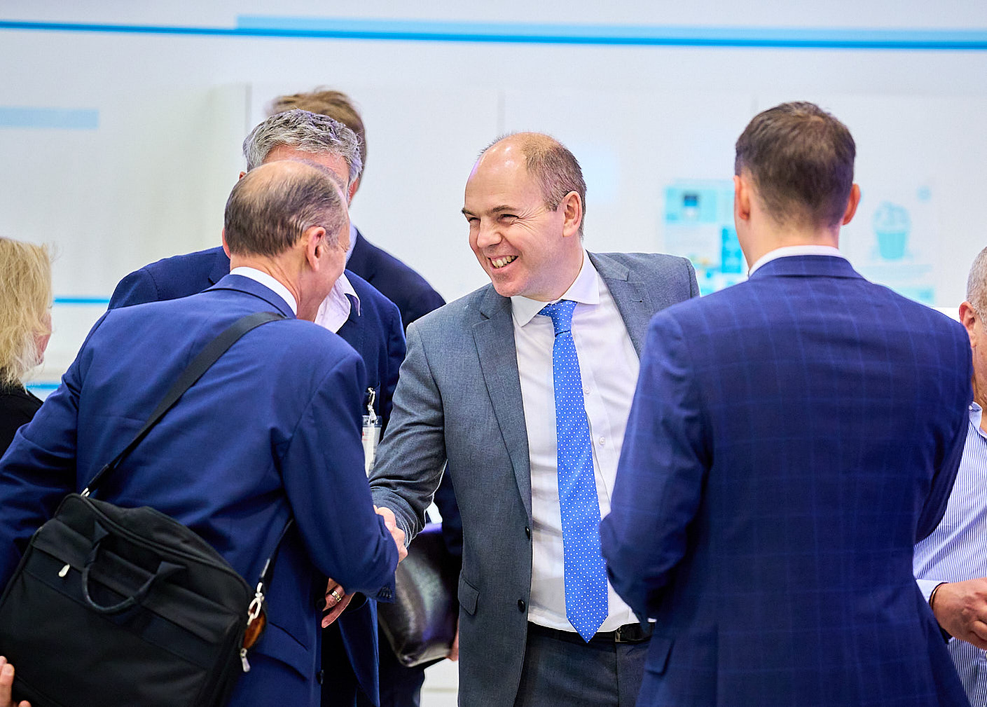 Businessmen meeting and greeting at a VR conference at CMC markets, photographed by Josh Caius.