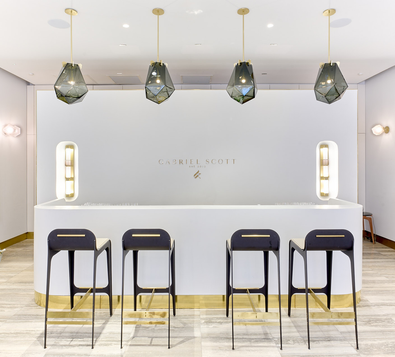 A white and gold bar with stools in front of it.