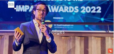 Josh Caius, London based award ceremony  event photographer for businesses. This is a photo for Digi Leaders at Ministry event space and is a close up of the giver of the award. 
