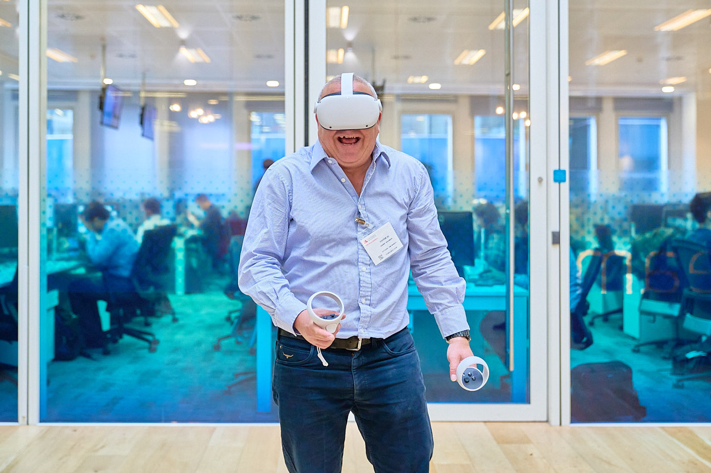 Man at a virtual reality educational conference enjoying a demo, with investment bankers' offices in the background.