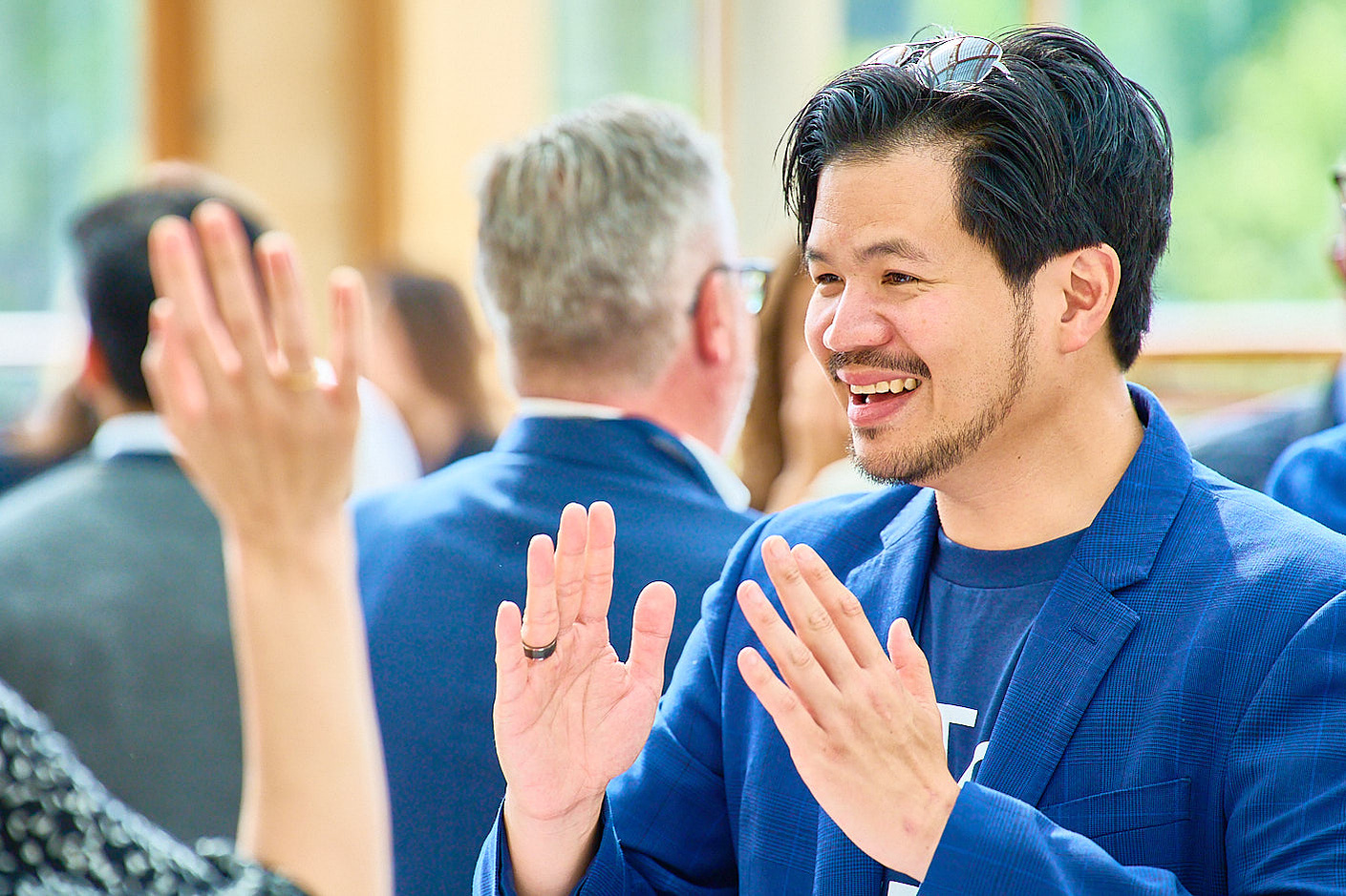 Corporate photography of guests talking during tea break at a panel discussion in Richmond, London.