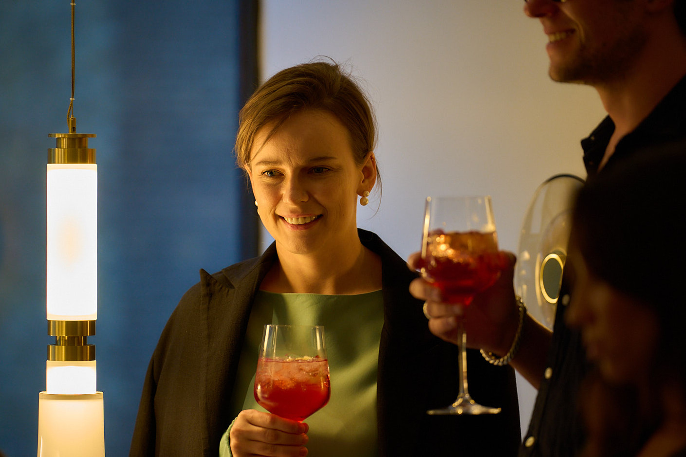An event photographer capturing a man with a glass of wine.