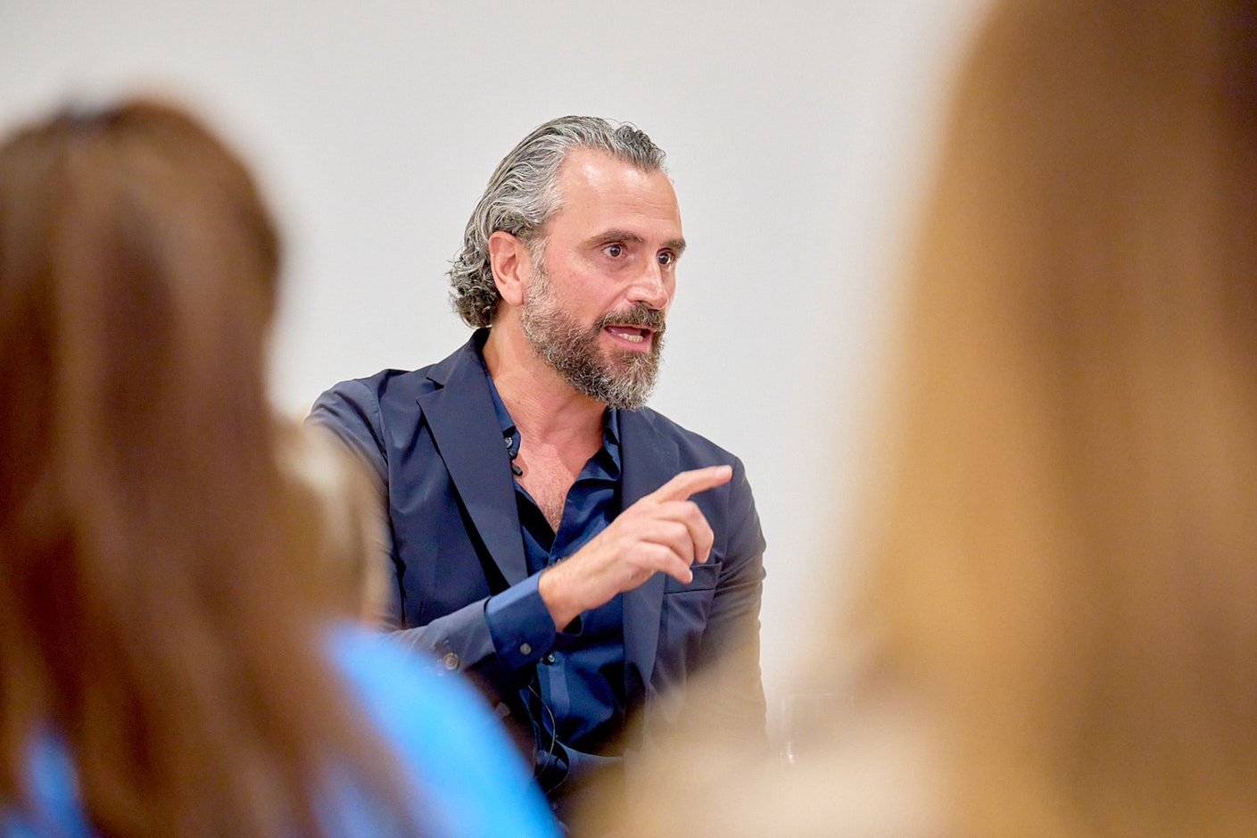 Alessandro Munge speaking to others in a networking event photographed by Josh Caius.