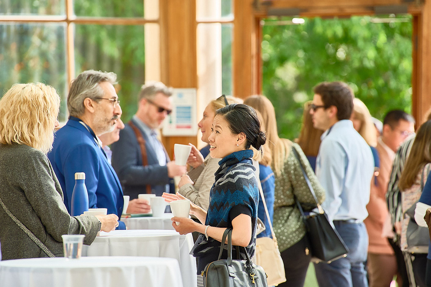 Photography of delegates at a corporate panel discussion having a break in Nash Conservatory