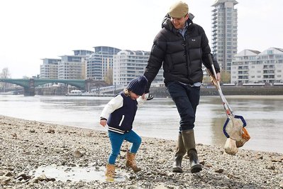 Public environmental PR photography by Josh Caius, for Thames21/Tideway in London. Children and adults picking litter around the Thames as part of a corporate day off event to help the local community.