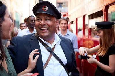 Luxury corporate fun day event photography by Josh Caius at London Transport Museum. This is a photo of the boss dressed up for fun during the event.