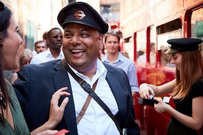 Luxury corporate fun day event photography by Josh Caius at London Transport Museum. This is a photo of the boss dressed up for fun during the event.