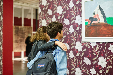 Josh Caius photographing installation shots with people in the photograph admiring the work of Philip Guston.
