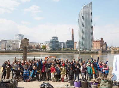 Public environmental PR photography by Josh Caius, for Thames21/Tideway in London. Children and adults picking litter around the Thames as part of a corporate day off event to help the local community.
