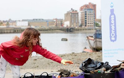 Public environmental PR photography by Josh Caius, for Thames21/Tideway in London. Children and adults picking litter around the Thames as part of a corporate day off event to help the local community.