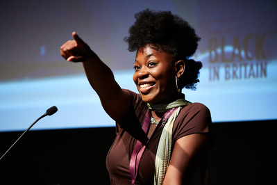 Museum talk photographer Josh Caius. A woman talks on stage for a day long event about diversity and blackness in relation to museums.