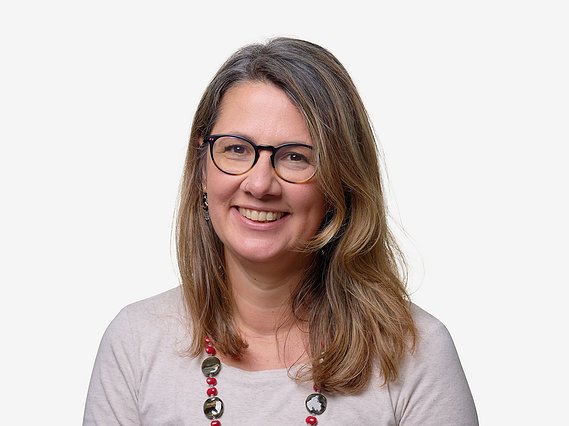 White background headshot for charity business Hand in Hand International. Natural relaxed happy headshots.