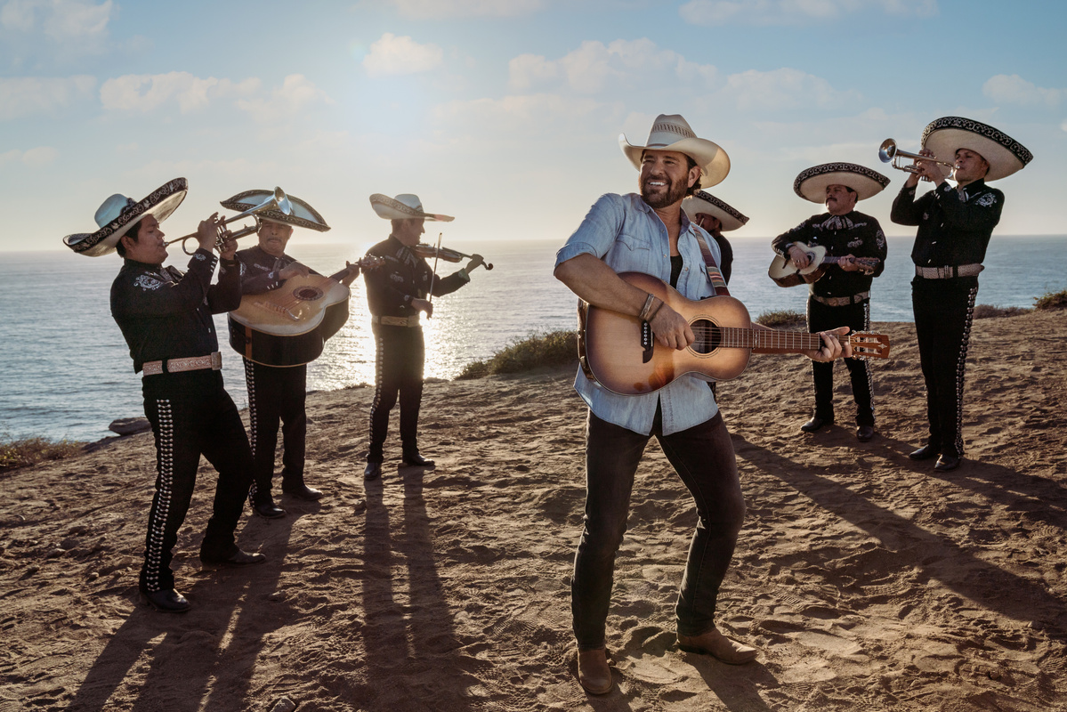 Todos Santos Mexico, Jon Wolfe plays music with band on the beach with the ocean in the background