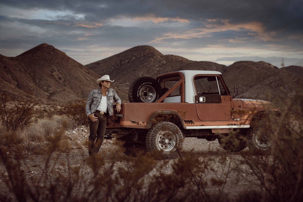 Jon Wolfe with old Jeep Renegade during sunset in Terlingua, Texas