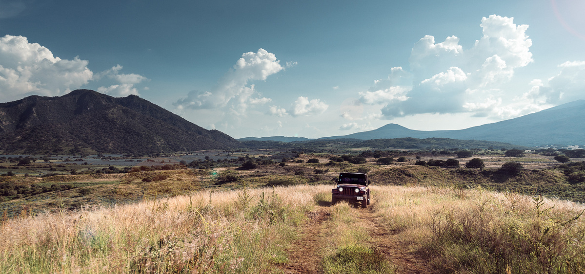 Jeep drives the vast landscape of Mexico with mountains in the distance. Juan Lobo Tequila
