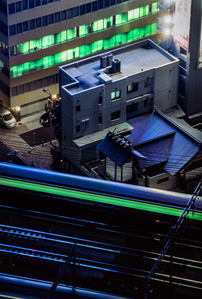 A bullet train crosses a bridge at night in Shiodome, Tokyo. 
Photograph from the series Forbidden Colours by Matthew James Fleming. Taken with a Nikon F100 and Fuji Velvia 50