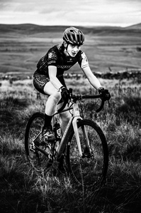 Victoria Peel, winner of first place position in the Women's Category, Three Peaks Cyclocross 2022, ascending Simon Fell. Photograph by Matthew Fleming.