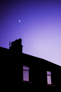 The moon rises over terraced houses in Clitheroe. Photograph taken by Matthew Fleming with a Hasselblad 500Cm and Fuji Velvia 50 film.