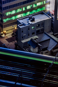 A bullet train crosses a bridge at night in Shiodome, Tokyo. 
Photograph from the series Forbidden Colours by Matthew James Fleming. Taken with a Nikon F100 and Fuji Velvia 50.